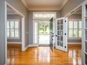 Bright entryway with hardwood floors and open view to backyard at 1945 Sw 40Th Pl, Ocala, FL 34471