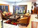 Elegant living room featuring ornate furniture and a large statement painting at 10502 Se 29Th Ave, Ocala, FL 34480