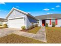 Home exterior view showcasing the garage and walkway at 3321 Sw 153Rd Place Rd, Ocala, FL 34473