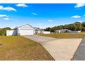 Cute house with a large driveway and white fence at 3321 Sw 153Rd Place Rd, Ocala, FL 34473