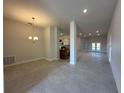 Open dining area with tile floor and views into the kitchen and living room at 4445 Sw 90Th Pl, Ocala, FL 34476