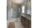 Main bathroom with double vanity, walk-in shower, and granite countertops at 4461 Sw 90Th Pl, Ocala, FL 34476