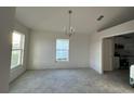 Spacious dining area with tile floors and chandelier at 4477 Sw 90Th Pl, Ocala, FL 34476