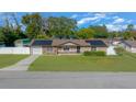 One-story home with solar panels, landscaped yard, and detached shed at 6931 Se 54Th St, Ocala, FL 34472
