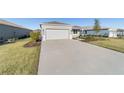 One-story home with gray exterior, two-car garage, and landscaped front yard at 9002 Sw 75Th Loop, Ocala, FL 34481