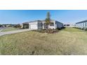 One story house with gray exterior, two car garage, and grassy yard at 9002 Sw 75Th Loop, Ocala, FL 34481