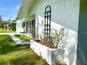 Side view of the house, showing a garden planter at 21111 Se Honeysuckle St, Dunnellon, FL 34431