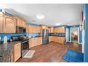 Spacious kitchen with light wood cabinets and granite countertops at 2201 Nw 135Th Ln, Citra, FL 32113