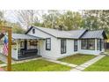 Renovated home with a gray swing and a metal roof at 2751 Ne 46Th St, Ocala, FL 34479