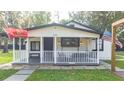 Updated farmhouse exterior, featuring a white facade and a porch at 2751 Ne 46Th St, Ocala, FL 34479