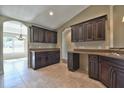 Spacious kitchen featuring dark wood cabinets and granite countertops at 5230 Nw 56Th Ter, Ocala, FL 34482