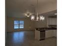 Bright living room features tile floors and a modern chandelier at 5489 Nw 12Th. St, Ocala, FL 34482