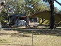 Backyard with a covered patio and a chain link fence at 611 Sw Shorewood Dr, Dunnellon, FL 34431