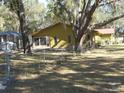 Home's back, featuring a screened enclosure and a chain link fence at 611 Sw Shorewood Dr, Dunnellon, FL 34431