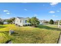 Side view of a single-story house with a palm tree and spacious yard at 9862 Se 179Th Pl, Summerfield, FL 34491