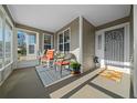 Relaxing screened porch with rocking chairs and a view of the yard at 10804 Sw 81St Court Rd, Ocala, FL 34481