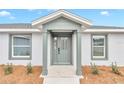 Front entrance with a stylish light gray door and sidelights at 2809 Ne 43Rd Rd, Ocala, FL 34470