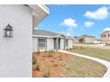 Side view of the house showcasing its gray siding and well-manicured landscaping at 2809 Ne 43Rd Rd, Ocala, FL 34470