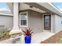 Front entrance with a decorative glass door and stone accents at 3977 Nw 46Th Ter, Ocala, FL 34482