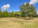 Landscaped backyard with lush trees and grass at 7732 Sw 94Th Cir, Ocala, FL 34481