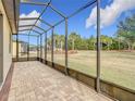 Spacious screened patio with paver floor and backyard view at 7732 Sw 94Th Cir, Ocala, FL 34481