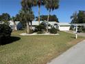 House exterior with palm trees, well-maintained lawn, and a driveway at 8433 Sw 108Th Place Rd, Ocala, FL 34481