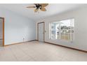 Bright living room featuring tile floors and a ceiling fan at 11852 Se 71St Ct, Belleview, FL 34420