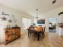Charming dining room with a wooden table and view into a bedroom at 15025 Sw 24Th Cir, Ocala, FL 34473