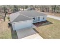 Aerial view of a single-story home, showcasing a grey roof and attached garage at 24440 Nw Falcon Ave, Dunnellon, FL 34431