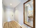 Light and airy entryway with wood-look floors and a large ornate mirror at 5032 Se 108Th St, Belleview, FL 34420