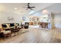 Open concept living and dining area with laminate floors and ceiling fan at 5032 Se 108Th St, Belleview, FL 34420