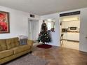 Open living room with a view into the kitchen and a Christmas tree at 8128 Fairways Cir # R101, Ocala, FL 34472