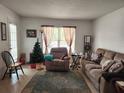 Cozy living room featuring a sofa and recliner at 8178 Fairways Cir # U201, Ocala, FL 34472