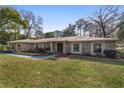 Ranch-style home with stone exterior, mature landscaping, and a spacious yard at 2528 Se 15Th St, Ocala, FL 34471