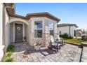 Front entry with gray door, stone accents, and paver walkway at 8873 Sw 59Th Lane Rd, Ocala, FL 34481