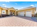 Two-story house with a three-car garage and brick paver driveway at 9015 Sw 86Th Loop, Ocala, FL 34481