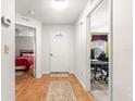 Bright entryway with wood floors, leading to bedroom and office at 9158 Sw 91St Ter, Ocala, FL 34481