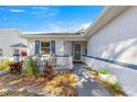 Front porch with seating and well-maintained landscaping at 9158 Sw 91St Ter, Ocala, FL 34481