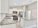 Modern kitchen featuring stainless steel appliances and granite countertops at 122 Pine Trce, Ocala, FL 34472