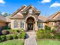 Elegant home exterior with stone accents and arched entryway at 3000 Nw 79Th Avenue Rd, Ocala, FL 34482