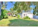 Large backyard with detached garage, gazebo, and lush landscaping at 6121 County Road 547 N, Davenport, FL 33837