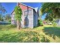 Two-story house, gray siding, red trim, and a large grassy yard at 6121 County Road 547 N, Davenport, FL 33837