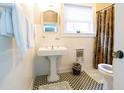 Classic bathroom with pedestal sink and tiled floor at 1200 W Lake Otis Se Dr, Winter Haven, FL 33880