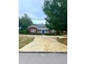 Brick home with a spacious front yard and long driveway at 1200 W Lake Otis Se Dr, Winter Haven, FL 33880