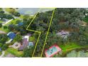Aerial view showcasing large lot with lake access and tennis court at 2060 Lake Ariana Blvd, Auburndale, FL 33823