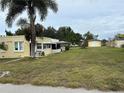Yellow house with detached garage, ample yard at 315 Virginia St, Frostproof, FL 33843