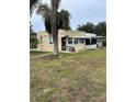 Yellow house with a screened porch and yard at 315 Virginia St, Frostproof, FL 33843