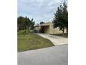 Yellow house with carport and spacious yard at 315 Virginia St, Frostproof, FL 33843