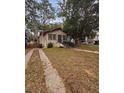 House exterior showing front yard, driveway, and mature trees at 1414 Johns Ave, Haines City, FL 33844