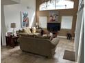 Spacious living room featuring neutral colored couches and large windows at 2213 Mallory Cir, Haines City, FL 33844